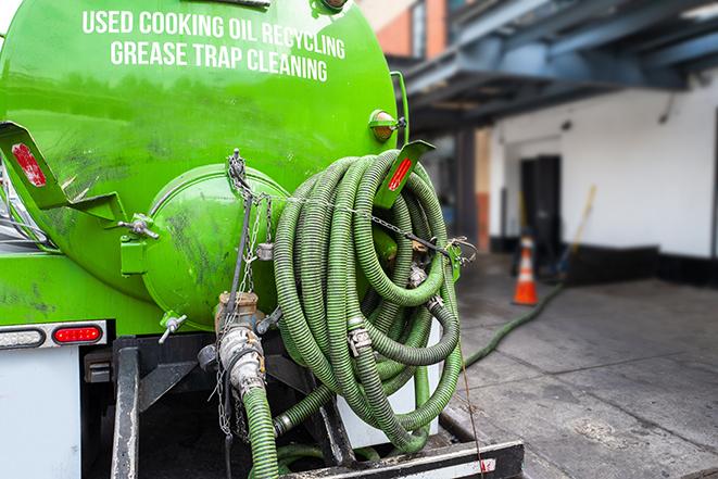 grease trap being pumped out by service technician in Arrington TN